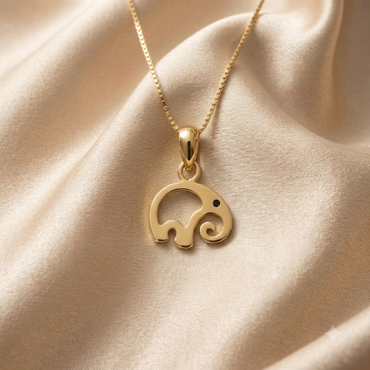 Gold pendant shaped like a swirled abstract elephant silhouette