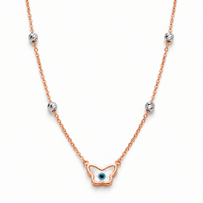 Rose gold chain necklace with a butterfly-shaped evil eye pendant and crystal bead stations. Luxe gifts for her under Rs. 60,000