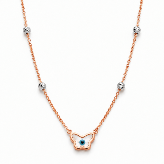 Rose gold chain necklace with a butterfly-shaped evil eye pendant and crystal bead stations. Luxe gifts for her under Rs. 60,000