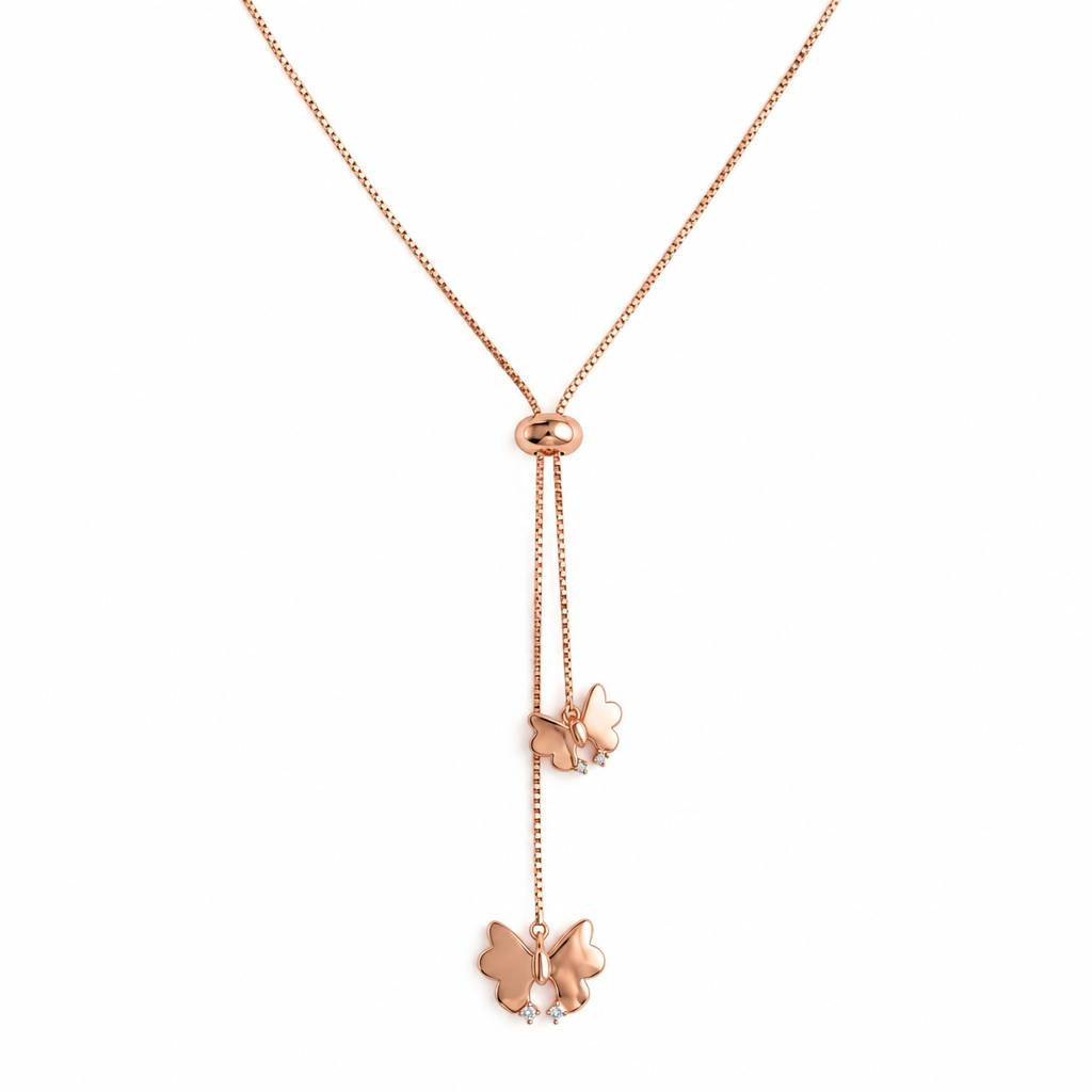 Rose gold lariat necklace with two dangling butterfly charms below a small oval clasp.