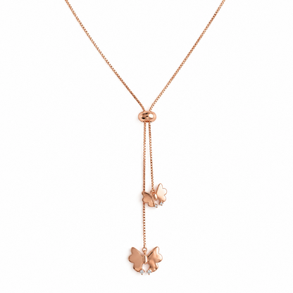 Rose gold lariat necklace with two dangling butterfly charms below a small oval clasp.