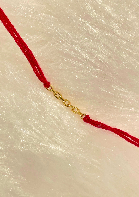 Elegant 18kt Gold Link Rakhi with intricate design for Raksha Bandhan celebration under Rs. 10,000 