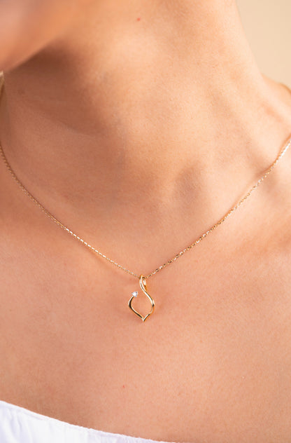 Elevate your everyday look with our delicate Twirly Diamond Pendant, crafted in 18kt gold. This playful design dances with every move, adding a touch of whimsy and sparkle to your attire, whether it's your workwear edit or casual ensemble. A perfect gift for her priced under 30,000, this pendant is both charming and versatile.