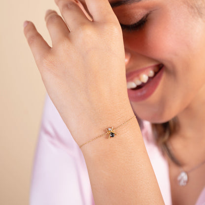 Black Cross Bracelet. 18kt gold, diamonds, and black stone. Affordable gold and diamond jewellery online under Rs 20,000. Trendy bracelets, rings, and necklaces in our 2024 collection. Best prices in India for stylish 18kt gold pieces. Gifts in gold for loved ones. Gold and diamond jewellery online, Latest collection, Best prices in India, Trendy jewellery.