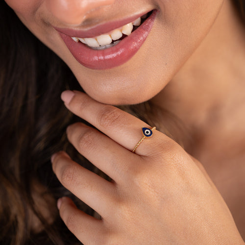 Elevate your style and protect yourself with our stunning 18 kt gold Evil Eye Ring, crafted with Natural Diamonds. This sleek design adds a touch of elegance to your everyday wear, work, or casual looks while warding off negativity. An ideal gift for her.