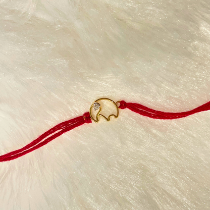 Elephant Rakhi in 18kt gold with a natural diamond, tied on red thread—BIS hallmarked, a Rakhi cum pendant symbolizing strength, wisdom & love under Rs. 15,000! 