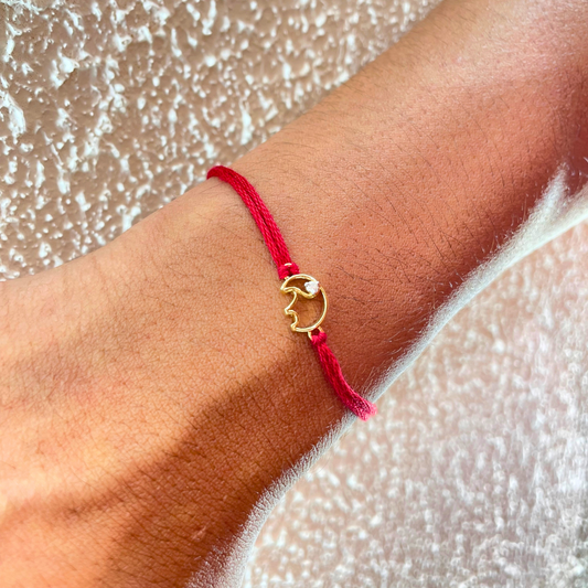 Elephant Rakhi in 18kt gold with a natural diamond, tied on red thread—BIS hallmarked, a Rakhi cum pendant symbolizing strength, wisdom & love under Rs. 15,000! 