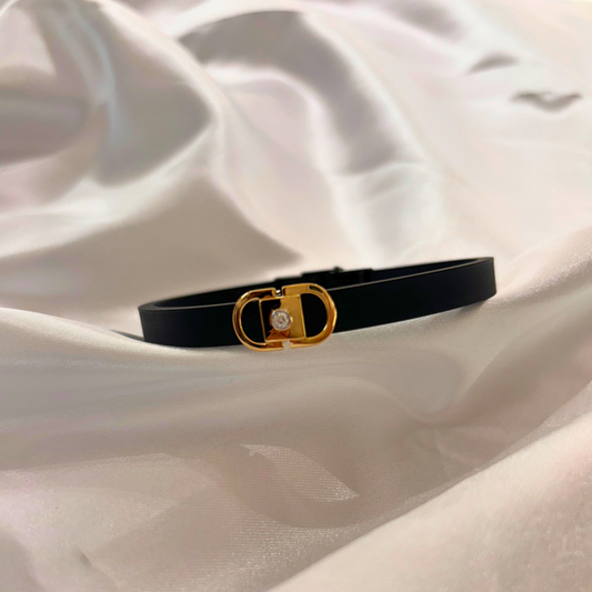 Men’s gold bracelet by Caratly, featuring a sleek black band with a central gold clasp adorned with a natural diamond, blending modern style with classic luxury under Rs. 30,000!