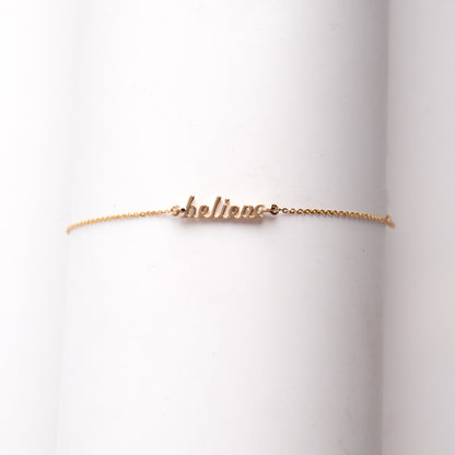 The elegant bracelet features the word “Believe” in a stylish font crafted from 18kt gold. Women's inspirational daily wear jewellery. Express your encouragement and support by gifting this. An affordable collection under Rs. 30,000.