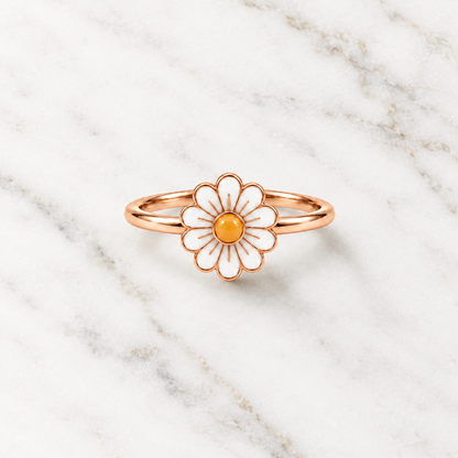 Rose gold ring with a white enamel daisy flower and a yellow center. Cute gifts for kids under Rs. 20,000