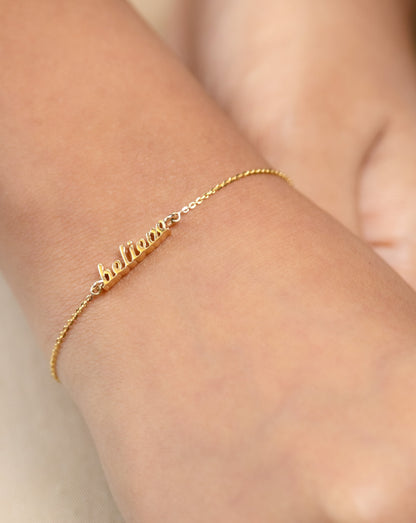 The elegant bracelet features the word “Believe” in a stylish font crafted from 18kt gold. Women's inspirational daily wear jewellery. Express your encouragement and support by gifting this. An affordable collection under Rs. 30,000.