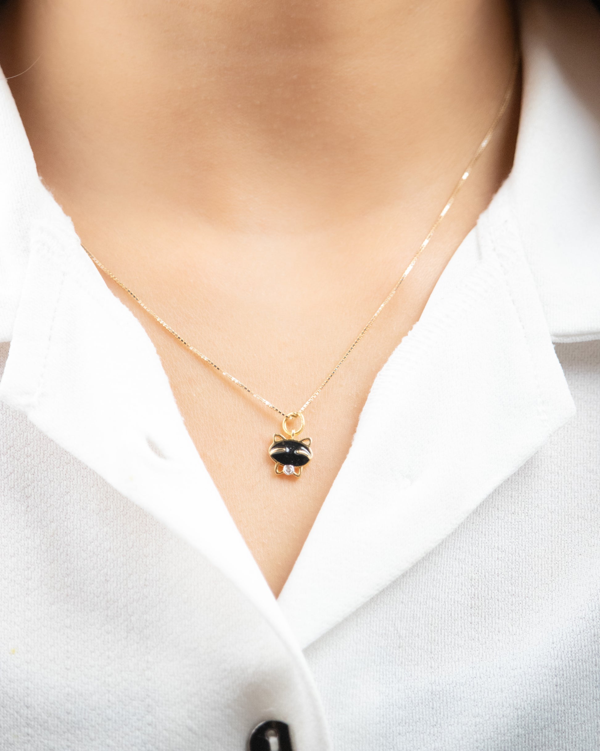 Elevate your everyday look with our 18kt gold Cat Diamond Charm. This charming piece is perfect for daily wear, adding a touch of elegance to any outfit. Whether it's for your 9 to 5 workwear edit or as a thoughtful gift for her, this affordable collection under 10,000 offers timeless sophistication.