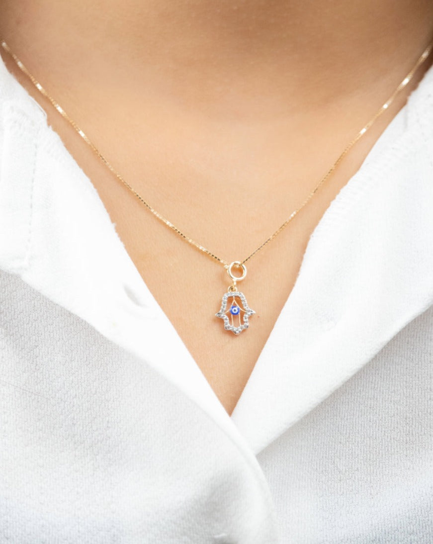 Capture timeless elegance with our Evil Eye Charm crafted in 18kt gold. Perfect for daily wear for women. Elevate your 9 to 5 outfit with our affordable collection, curated for the modern woman. Luxury gifting ideas under 30,000 collections. Embrace style and protection with our Evil Eye Charm.