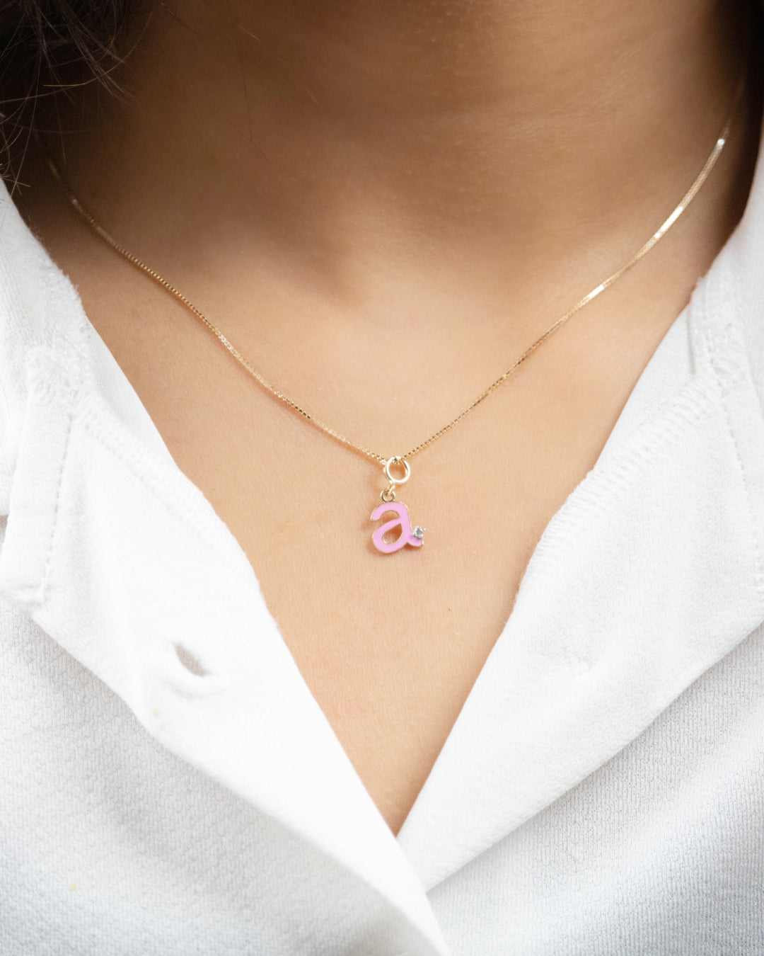 Express yourself with our charming 18kt Gold Pink Letter Charm. This piece is perfect for daily wear for women. It's a perfect gift for her or a chic addition to your workwear wardrobe. Explore our affordable collection under 10,000. 