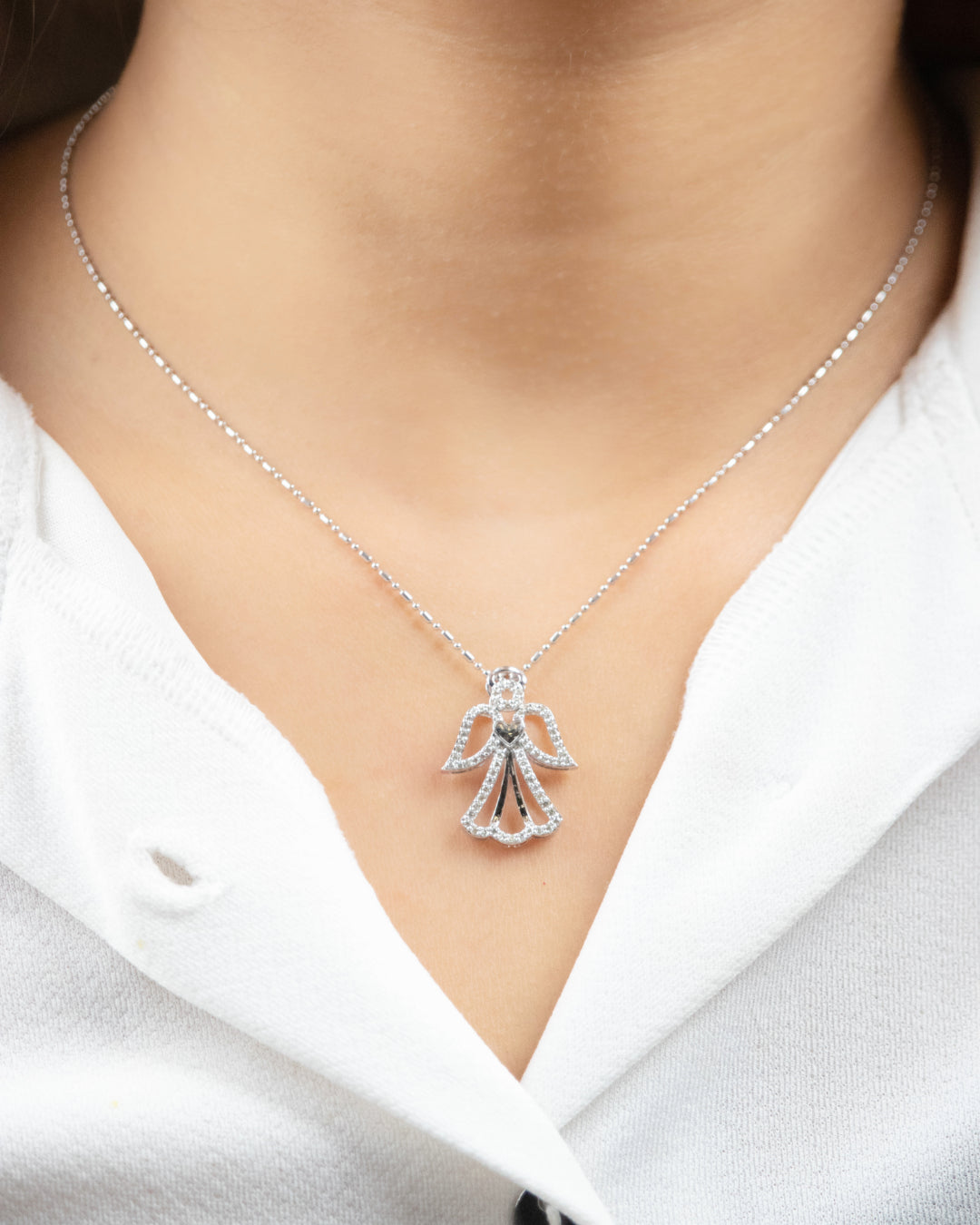 Embrace divine protection with our Guardian Angel Pendant crafted in luxurious 18kt gold. It's designed for daily wear for women, providing a symbol of strength. A heartfelt gift for her under 50,000. 