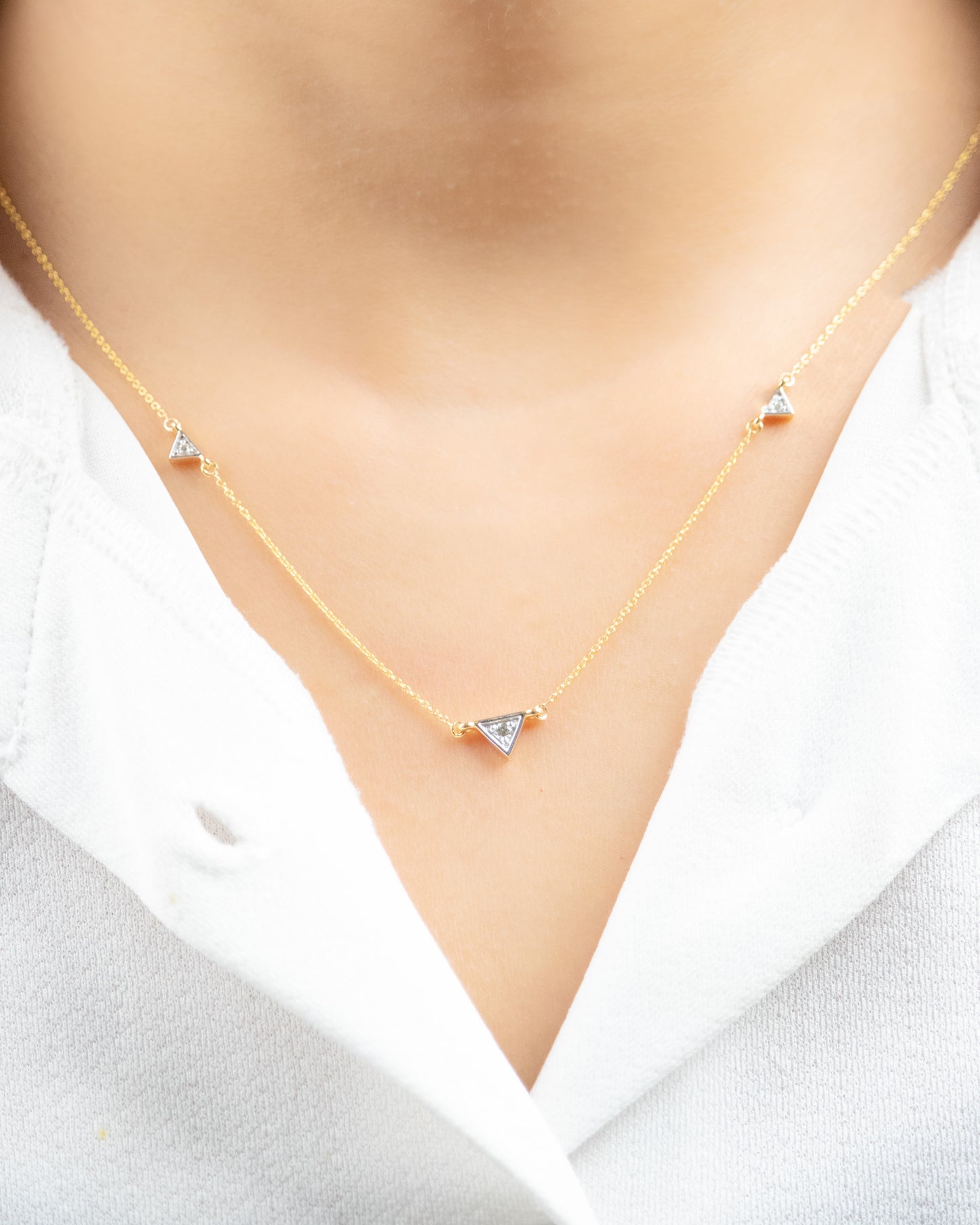 Triangle Diamond Necklace crafted from radiant 18kt gold for women. Elevate her everyday look by gifting this beautiful piece of everyday wear jewellery from the collection under Rs. 30,000.