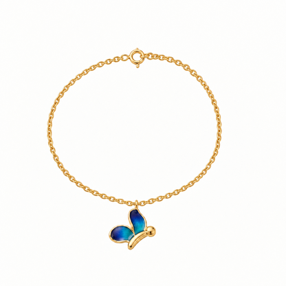 Gold chain bracelet with an enamel blue butterfly charm dangling priced under Rs. 30,000.