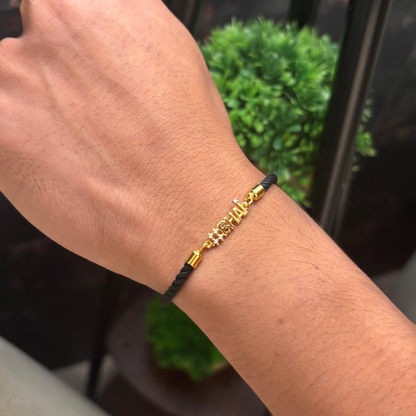 Black cord men's diamond bracelet featuring an 18kt gold '#BHAI' charm with sparkling diamond accents. A perfect minimal gift for brother under Rs. 20,000