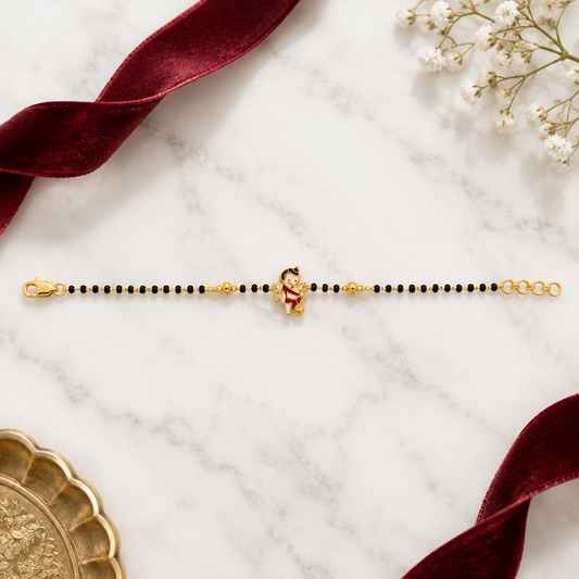 Black bead bracelet with a gold Hanuman charm at the center priced under Rs. 35,000