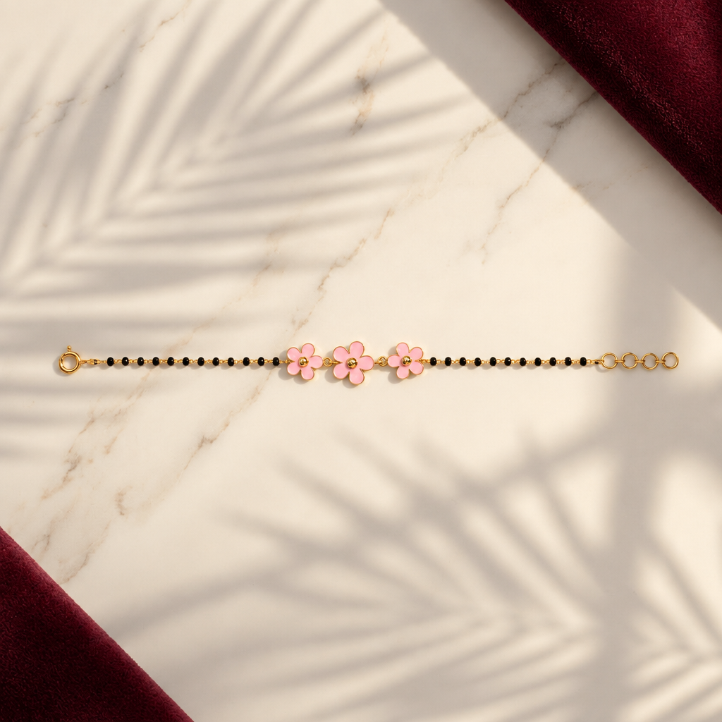 Black bead bracelet with three pink enamel flower charms. Gift for kids under Rs. 50,000
