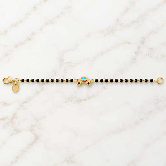 Black bead bracelet with a red and gold race car charm at the center priced under Ra. 30,000