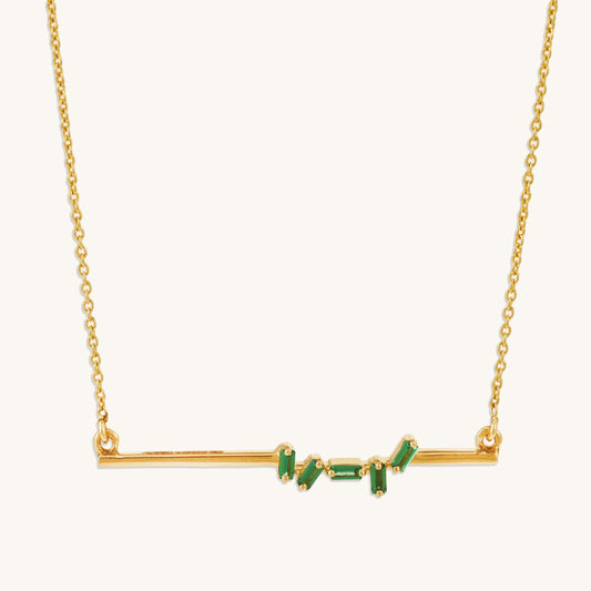 Caratly 18kt gold Baguette Emerald Necklace featuring scattered green baguette-cut emeralds on a horizontal gold bar pendant with attached chain under Rs. 40,000