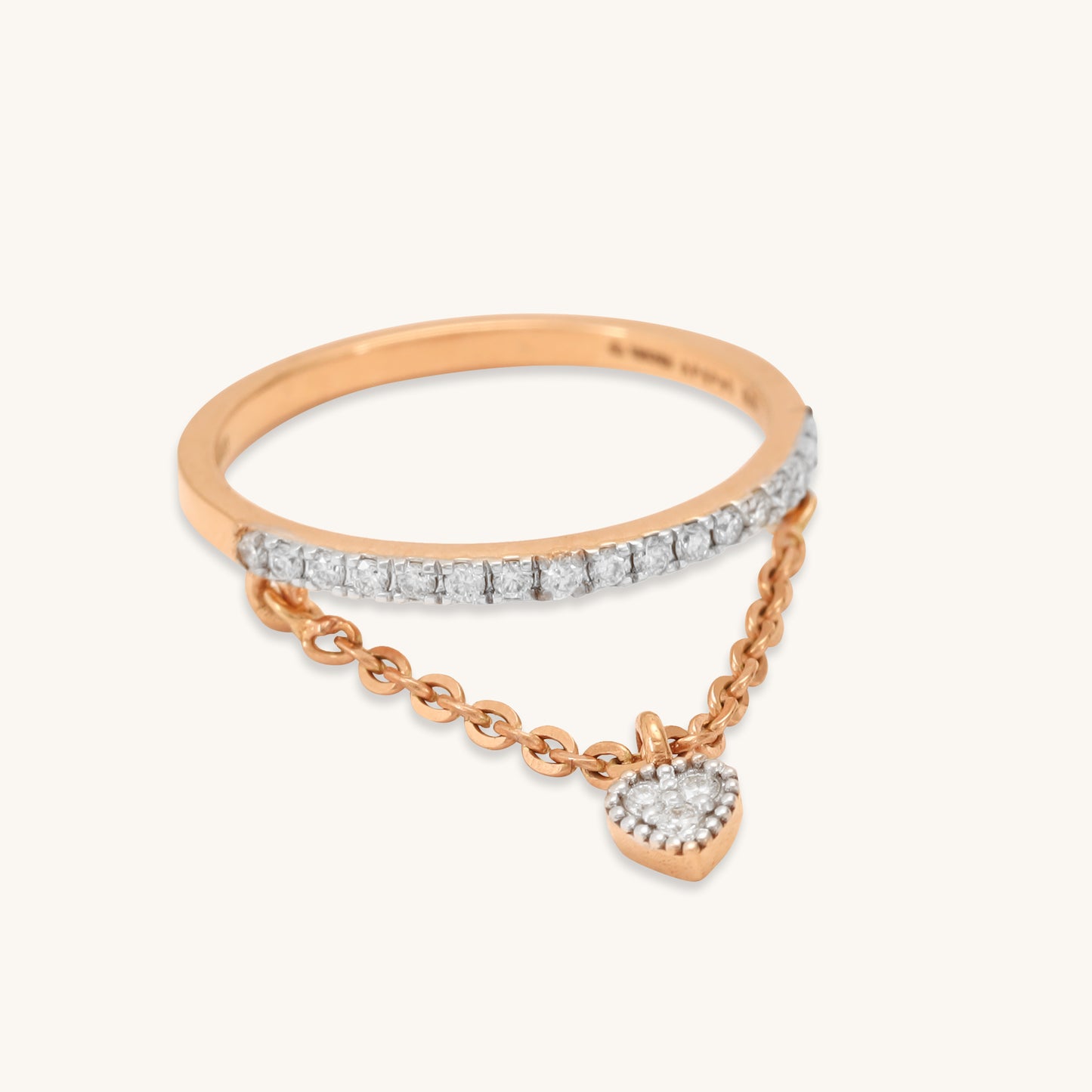 Caratly 18kt gold Dangling Diamond Ring featuring a straight pave diamond band with an attached draped chain holding a tiny diamond heart charm under Rs. 50,000