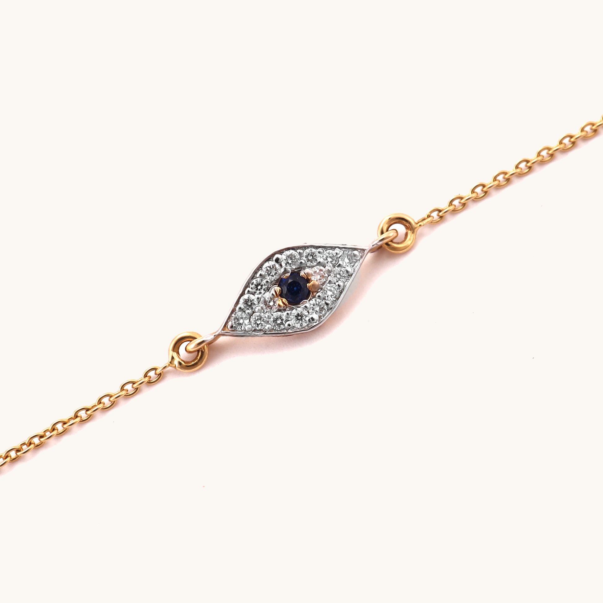 Caratly 18kt gold Evil Eye Bracelet featuring a marquise-shaped charm with a dark blue center stone surrounded by pave diamonds. Evil eye bracelet gift for her under Rs. 25,000