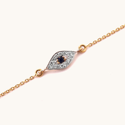 Caratly 18kt gold Evil Eye Bracelet featuring a marquise-shaped charm with a dark blue center stone surrounded by pave diamonds. Evil eye bracelet gift for her under Rs. 25,000