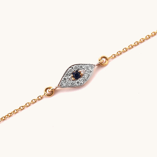 Caratly 18kt gold Evil Eye Bracelet featuring a marquise-shaped charm with a dark blue center stone surrounded by pave diamonds. Evil eye bracelet gift for her under Rs. 25,000