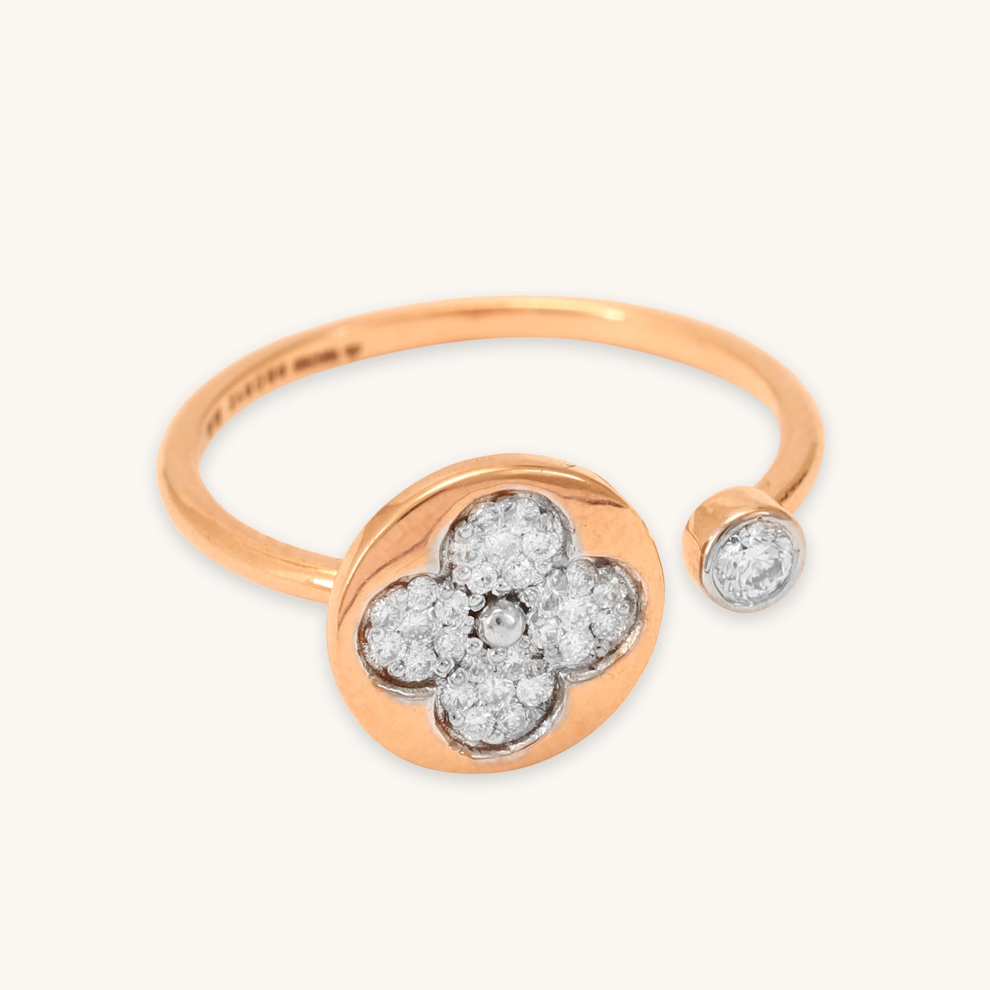 Caratly 18kt gold Flower Diamond Ring featuring an open bypass design with a diamond clover shape on one end and a small round bezel diamond on the other.