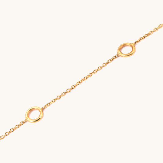 Caratly 18kt gold Charm Bracelet base chain featuring evenly spaced circular rings designed for clipping on personalized charms. Customizable gifts under Rs. 20,000