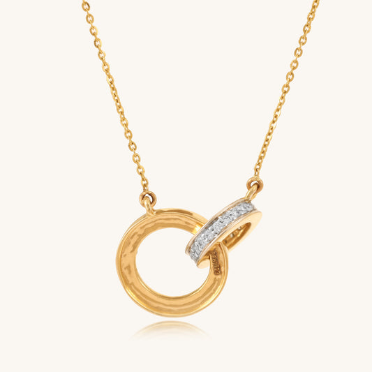 Caratly 18kt gold Interlocked Diamond Necklace featuring two connected circle pendants, one in plain textured gold and one set with 0.15ct pave diamonds, attached to a gold chain