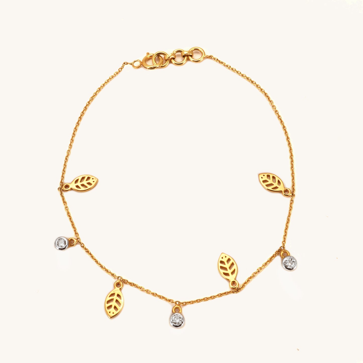 Caratly 18kt gold Leaf Diamond Bracelet featuring a delicate chain with alternating dangling open gold leaf charms and round diamond accents under Rs. 40,000
