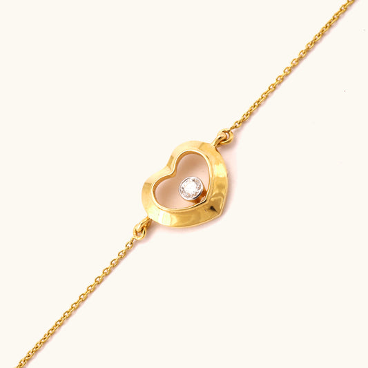 Caratly 18kt gold Love Diamond Bracelet featuring a polished open heart charm with a single bezel-set diamond floating in the center. Perfect minimal gift for her under Rs. 40,000