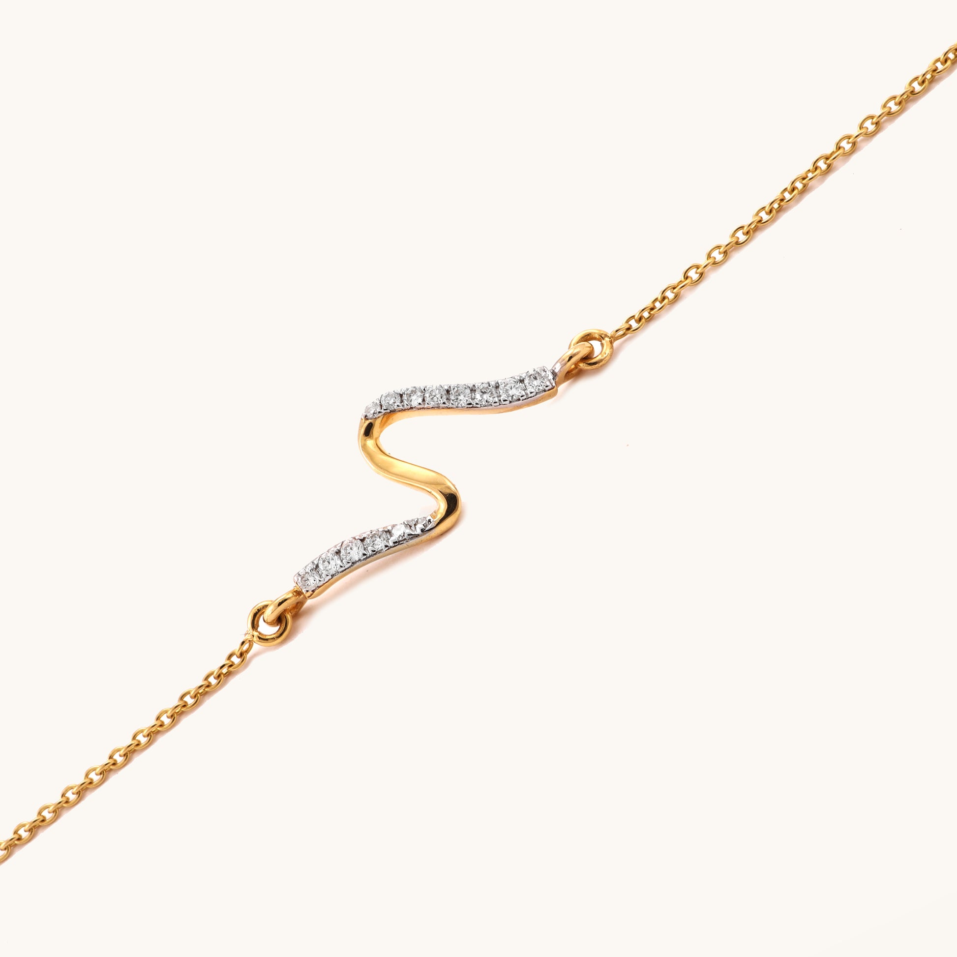 Caratly 18kt gold Swirl Diamond Bracelet featuring a smooth, fluid S-curve wave motif partially set with pave diamonds. Everyday minimal designs for her under Rs. 25,000