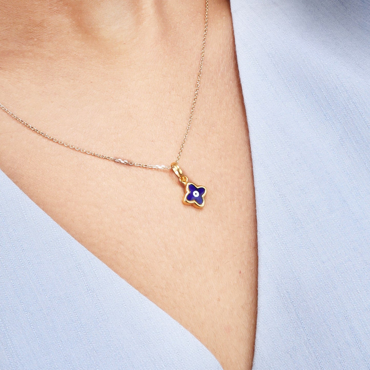 Caratly 18kt gold Baby Evil Eye Pendant featuring a tiny dark blue enamel clover-shaped evil eye charm under Rs. 15,000 