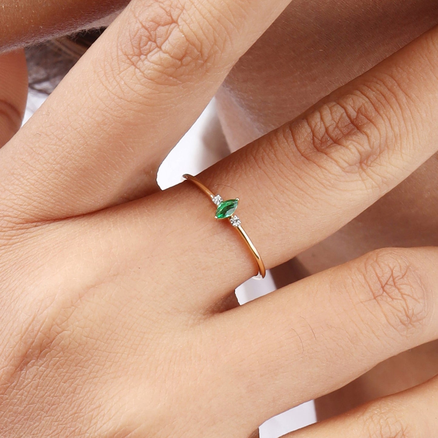 Caratly 18kt gold Green Diamond Ring featuring a very thin band with a central marquise or leaf-shaped green gemstone and two small round side diamonds under Rs. 20,000