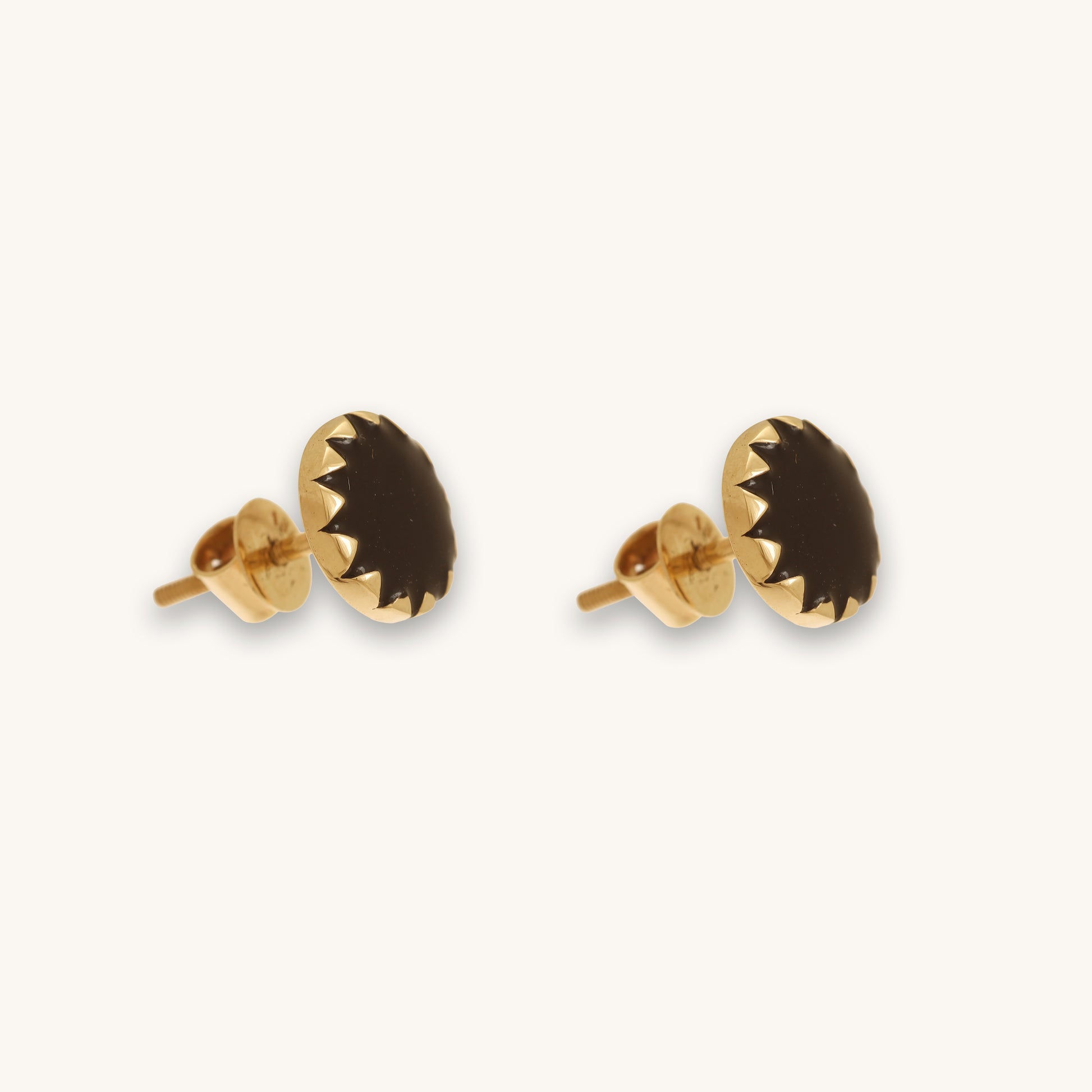 Caratly 18kt gold Round Gold Earring featuring a dark, flat circular center with a jagged, sunburst-style gold bezel setting under rs. 30,000