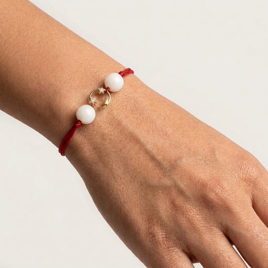 Gold moon and star diamond Rakhi with white beads.
