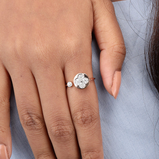 Caratly 18kt gold Flower Diamond Ring featuring an open bypass design with a diamond clover shape on one end and a small round bezel diamond on the other.