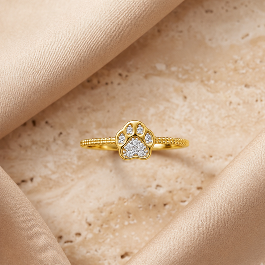 Gold ring with a heart-shaped paw print charm set with sparkling diamonds under Rs. 35,000