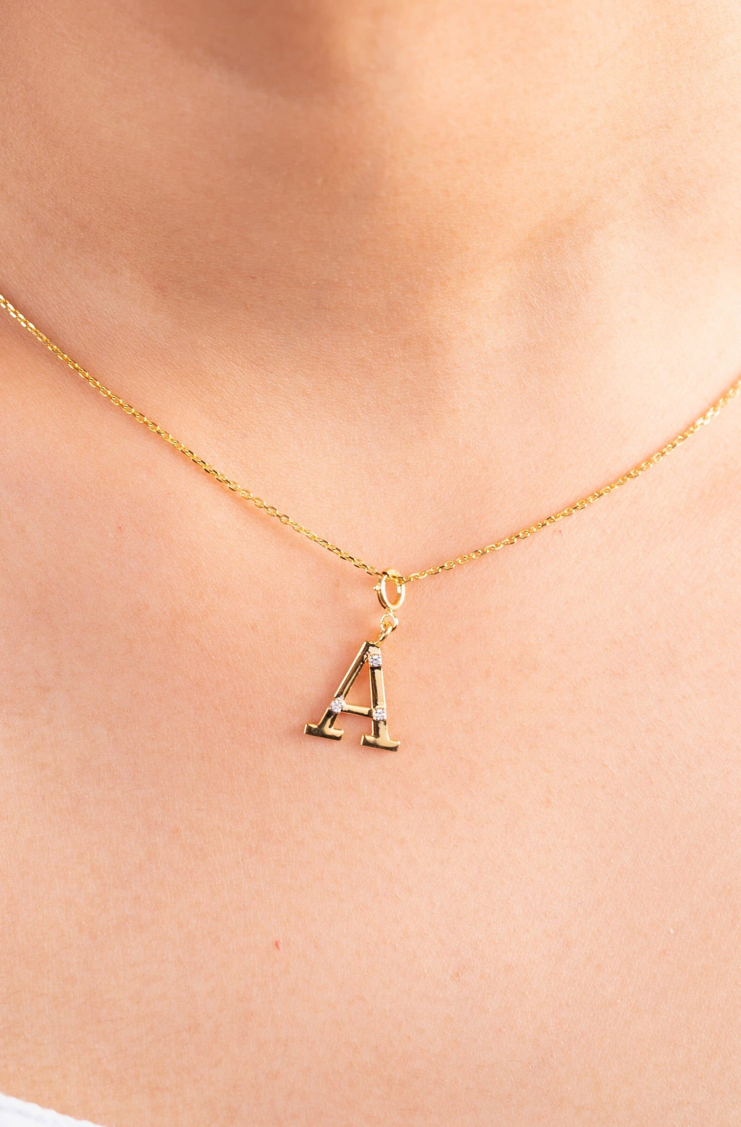 Make a personal statement with our 18kt 'A' Initial Diamond Pendant from the Spring Edit. Priced under 10,000, this elegant piece is a thoughtful gifting idea for your loved ones. Elevate their style with this exquisite jewelry—a cherished symbol of affection.