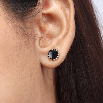 Caratly 18kt gold Round Gold Earring featuring a dark, flat circular center with a jagged, sunburst-style gold bezel setting under rs. 30,000