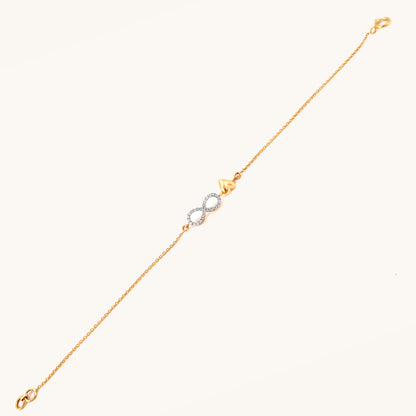 Caratly 18kt gold Infinity Love Bracelet featuring a diamond pave infinity loop intertwined with a small polished solid gold heart charm. Minimal Everyday Wear Gift for her under Rs. 40,000