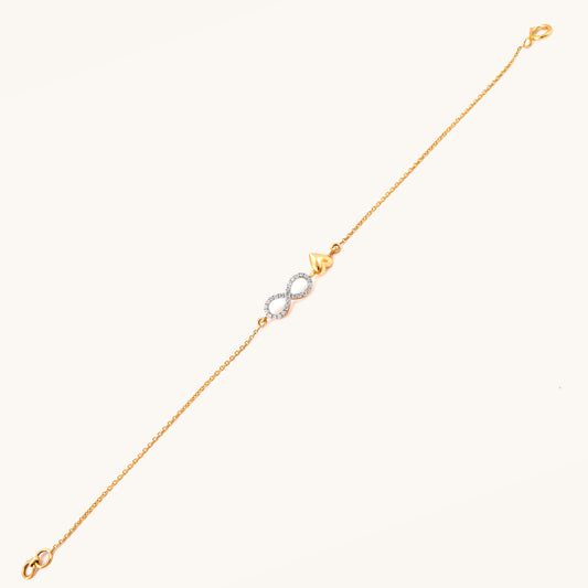 Caratly 18kt gold Infinity Love Bracelet featuring a diamond pave infinity loop intertwined with a small polished solid gold heart charm. Minimal Everyday Wear Gift for her under Rs. 40,000