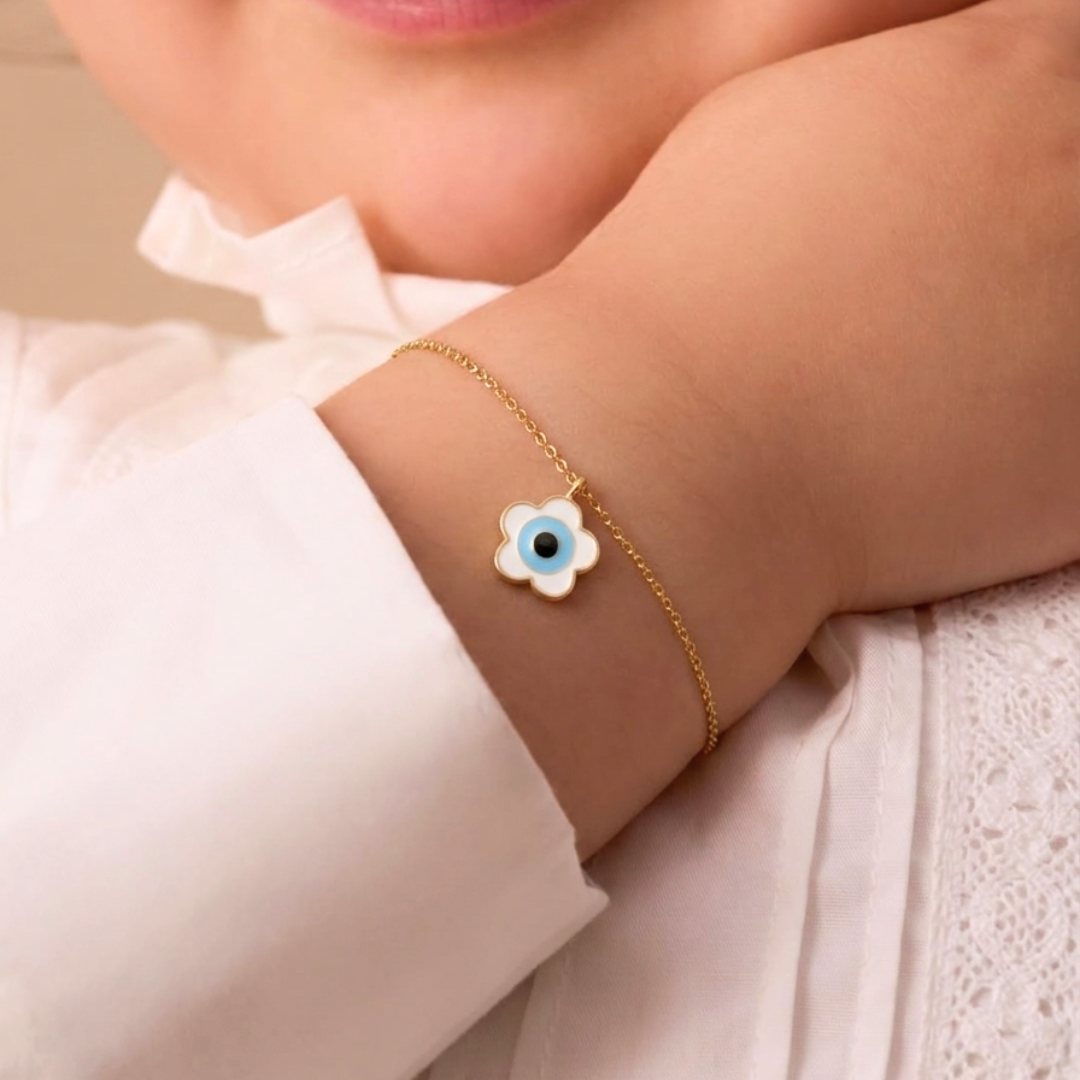 Delicate gold chain bracelet with a white flower-shaped evil eye charm under Rs. 25,000