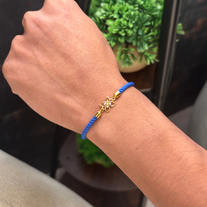 Blue rope men's diamond bracelet with an 18kt gold floral charm and sparkling diamond center under Rs. 15,000