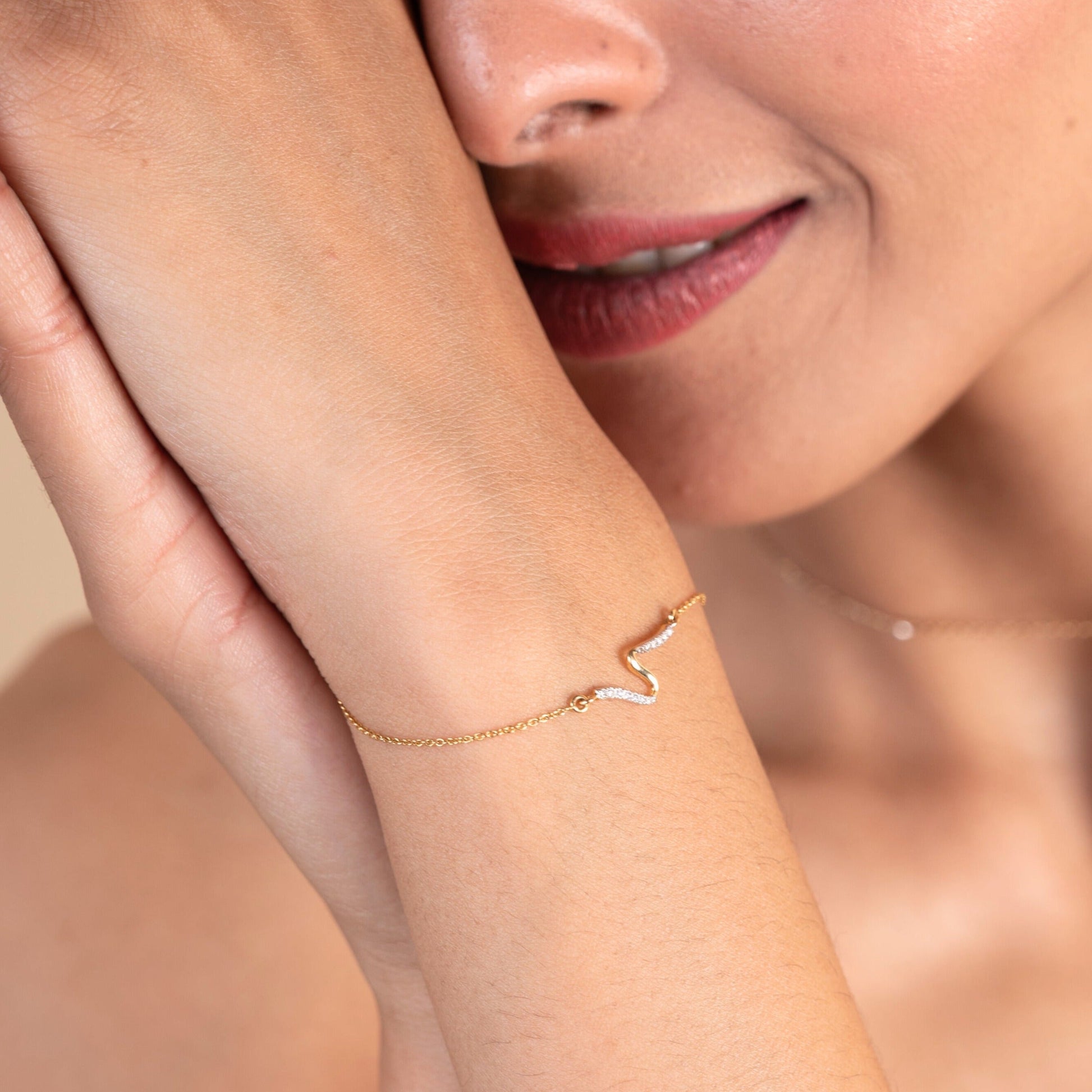 Caratly 18kt gold Swirl Diamond Bracelet featuring a smooth, fluid S-curve wave motif partially set with pave diamonds. Everyday minimal designs for her under Rs. 25,000
