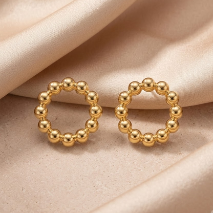Gold stud earrings formed from a ring of small polished gold beads. Priced under Rs. 25,000